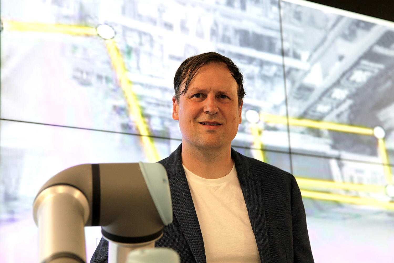 Professor Mikkel Baun Kjærgaard with exteded robot arm
